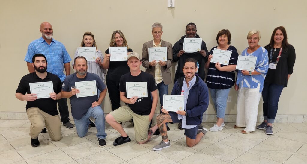 A group of people standing with certificates.